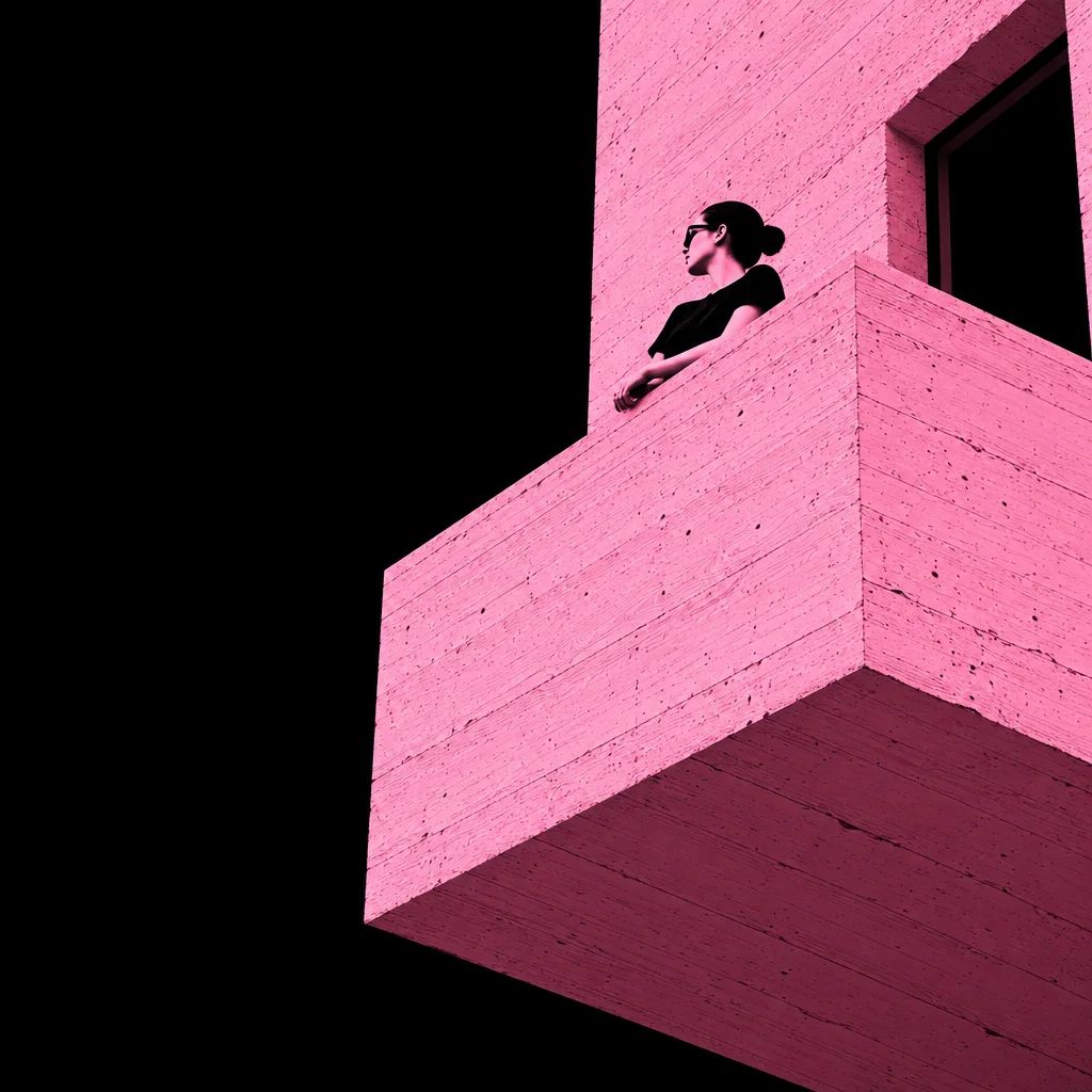 A woman wearing sunglasses leans on a minimalist pink textured concrete balcony against a stark black void.