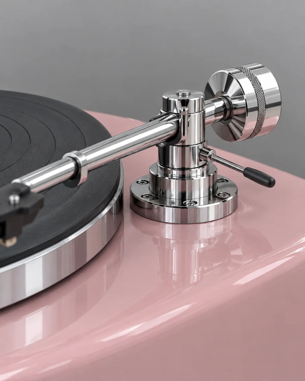A precision-machined chrome tonearm and counterweight assembly mounted on a glossy blush pink turntable plinth.