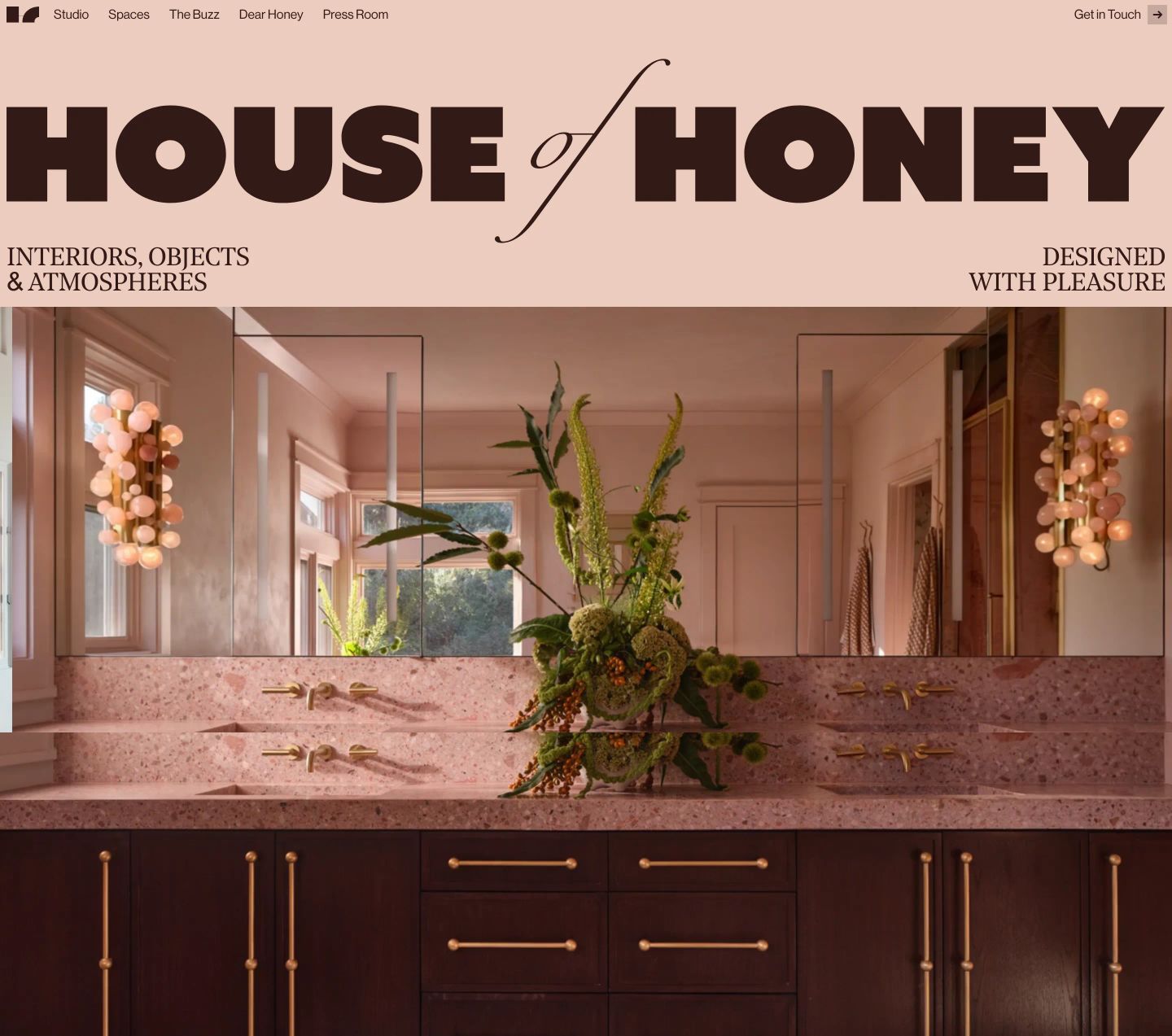 Luxurious warm-toned editorial hero featuring an ultra-bold vintage masthead over a rich, symmetrical interior photography showcase.