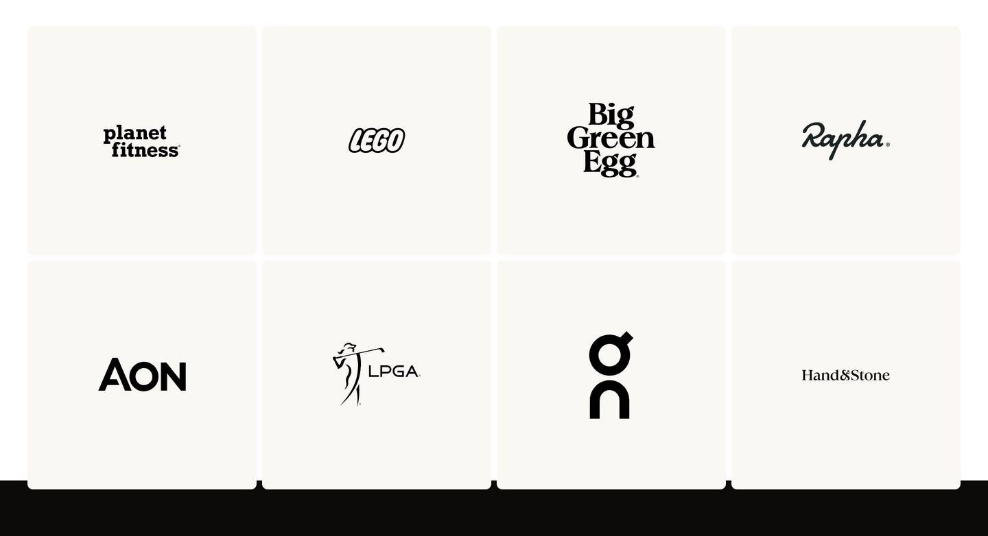 Quiet, spacious grid of monochrome brand marks isolated in soft cream square tiles.