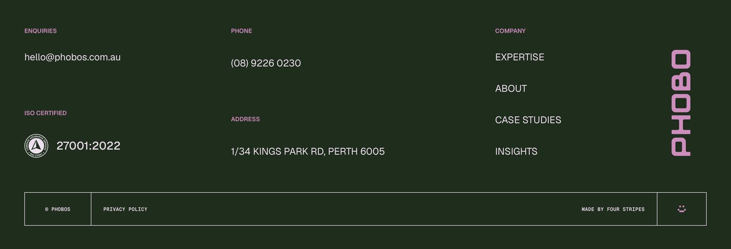 A dark forest-green technical footer structured with precise micro-copy, vertical branding, and subtle pinkish typography.