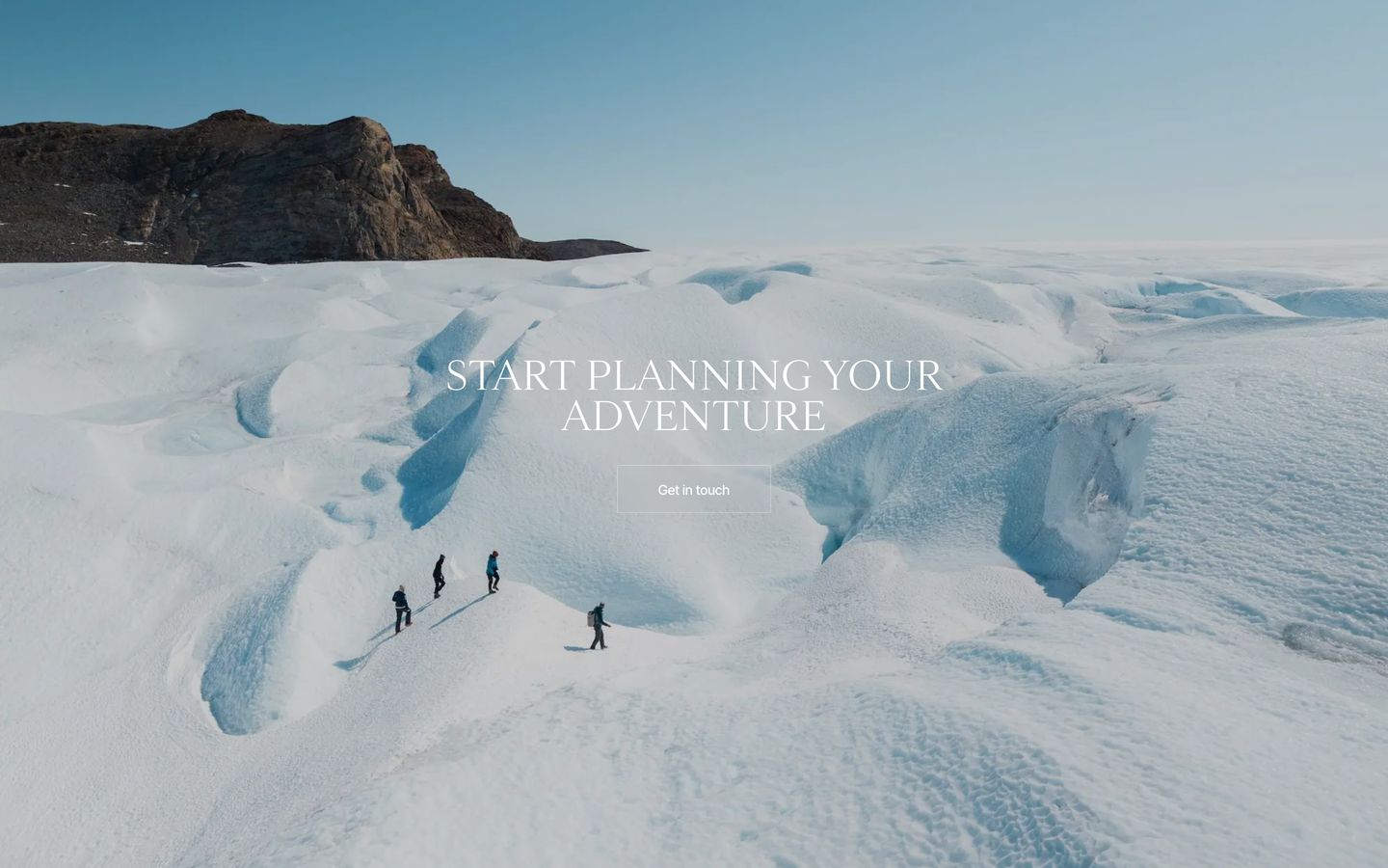 A vast, silent glacial expanse opens up beneath a refined serif invitation to explore.